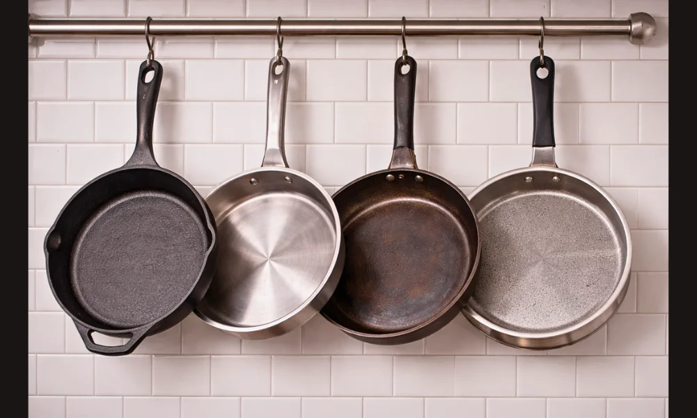 Cookware hanging by handles showing weight load