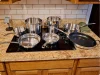 Cuisinart MultiClad Pro 15-piece cookware set arranged on a kitchen cooktop