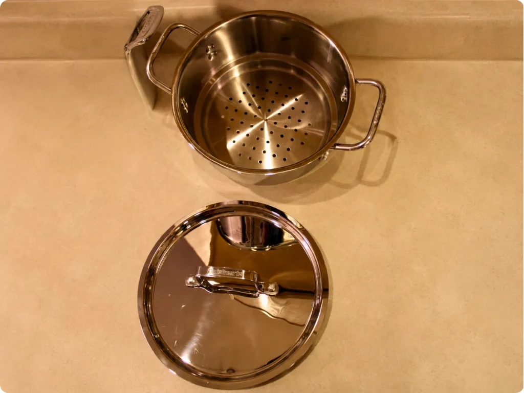 Cuisinart MultiClad Pro steamer insert inside a stainless steel pot with lid